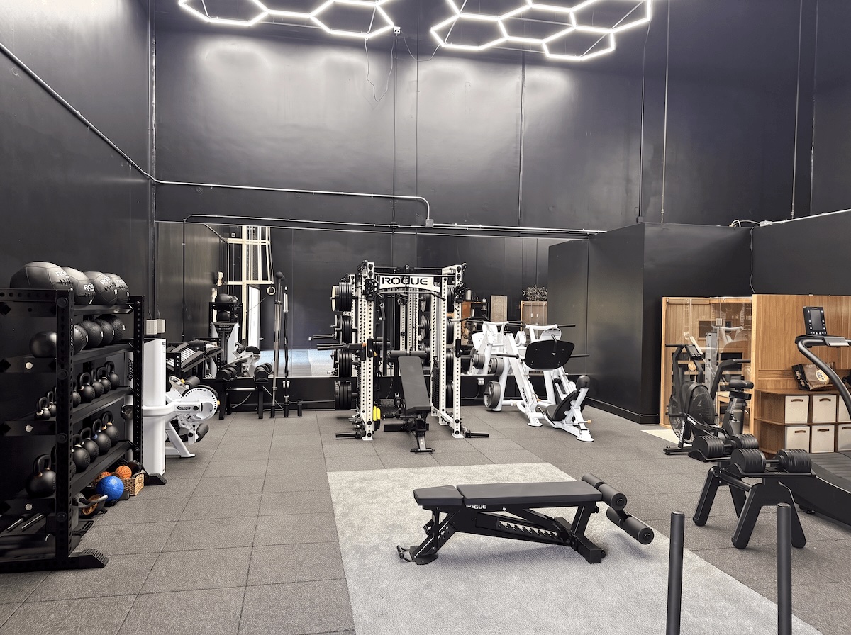 Strength and functional training zone with power rack, Hoist leg press, and rubber tile flooring