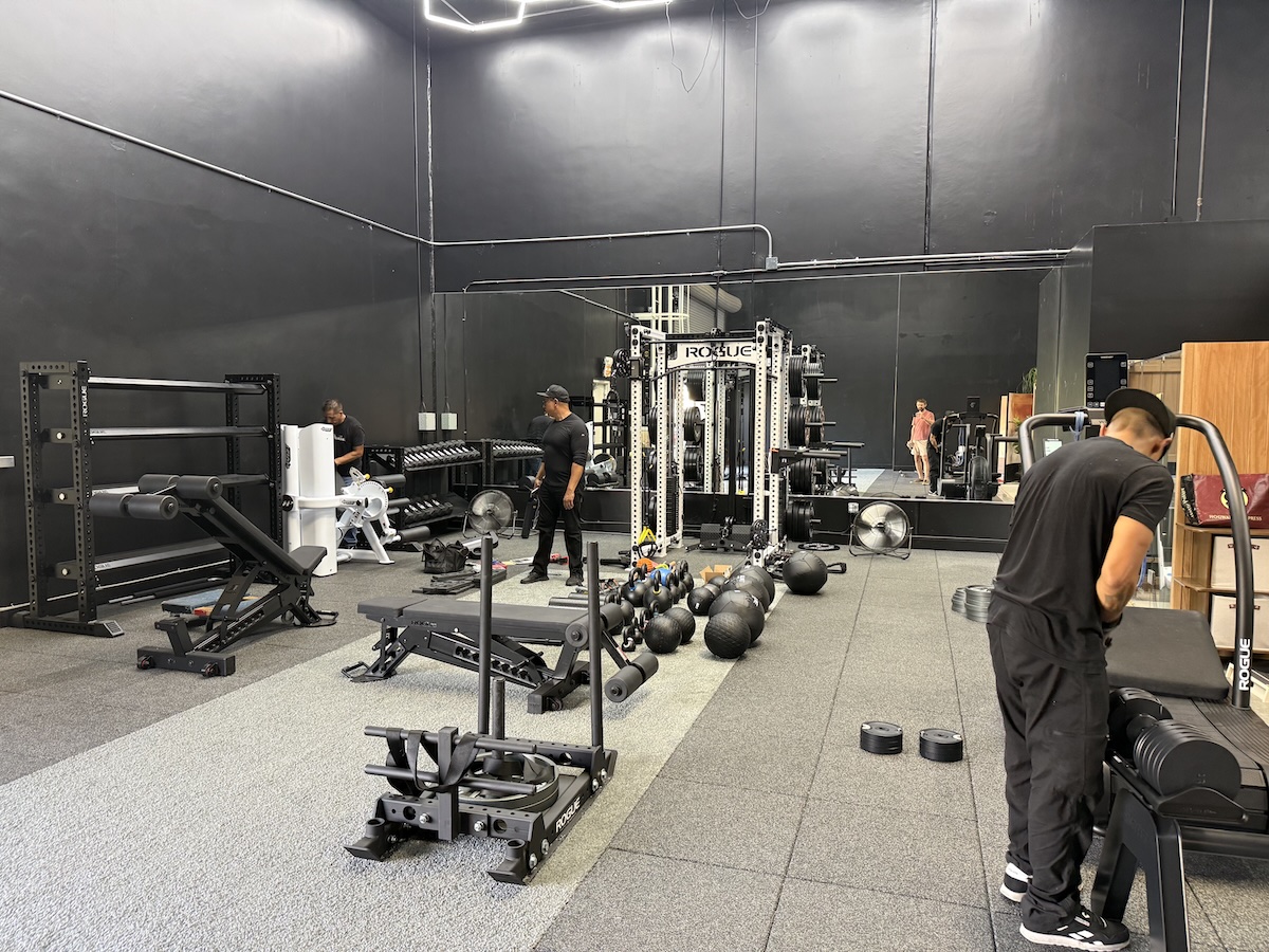 Gym Provisions technicians assembling Rogue equipment during the warehouse installation